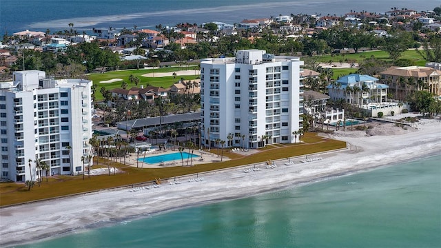 drone / aerial view with a water view and a beach view