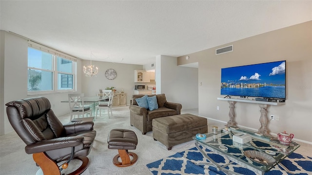 carpeted living room with a textured ceiling and a notable chandelier