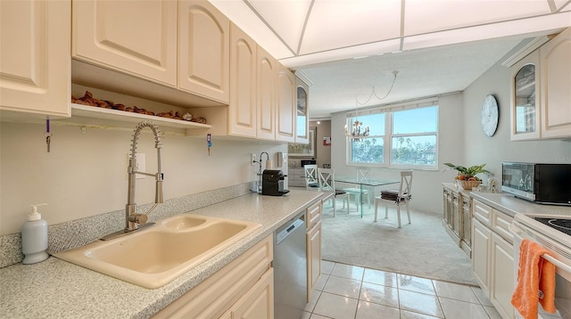 kitchen with light carpet, sink, and appliances with stainless steel finishes