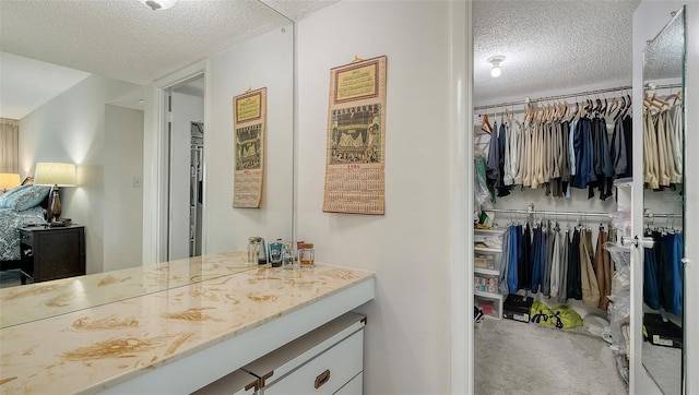 bathroom with a textured ceiling and vanity