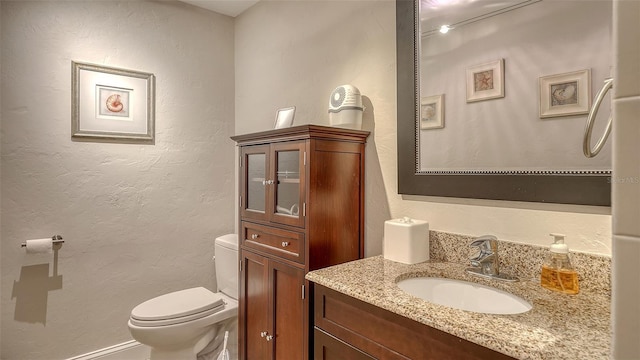 bathroom featuring toilet and vanity