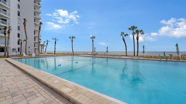 view of pool with a water view