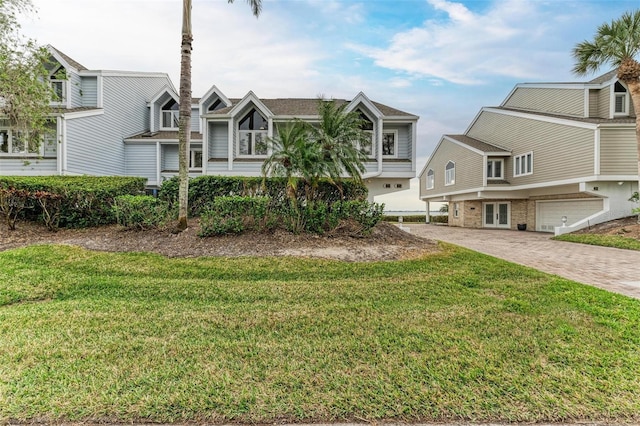 view of front of property featuring a garage and a front lawn