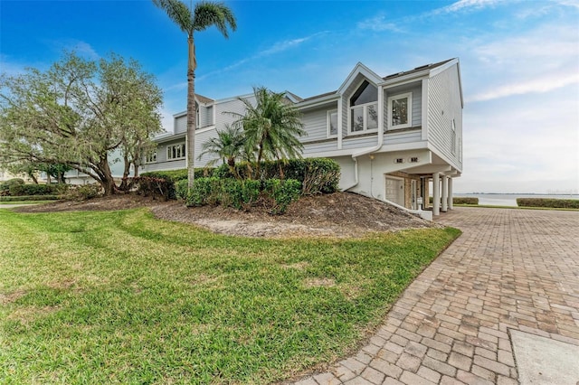 view of home's exterior with a garage and a yard