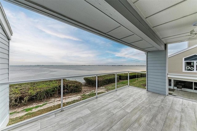 deck featuring a water view and ceiling fan