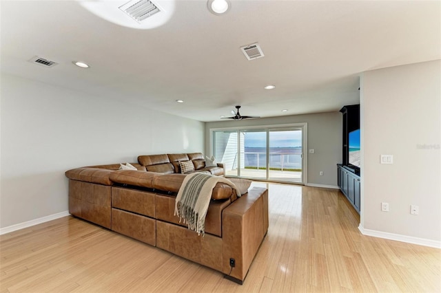 living room featuring ceiling fan and light hardwood / wood-style floors