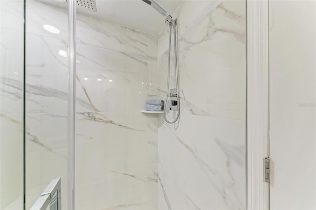 interior details featuring tiled shower