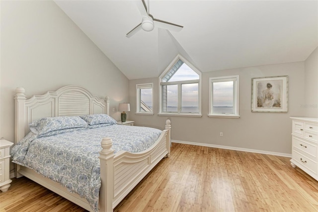 bedroom featuring light hardwood / wood-style flooring, vaulted ceiling, and ceiling fan