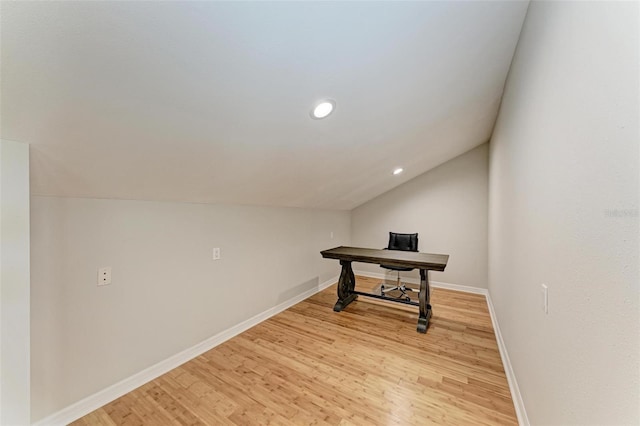 office with light hardwood / wood-style floors and vaulted ceiling