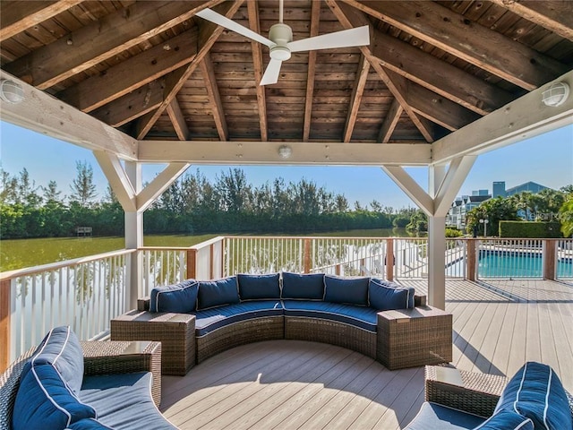 deck featuring a covered pool, ceiling fan, a gazebo, and an outdoor hangout area