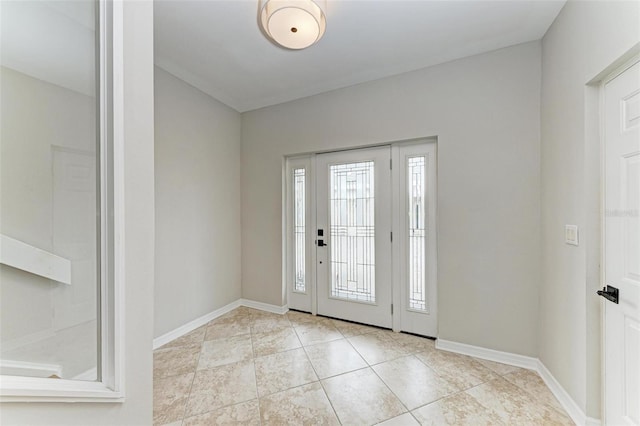 foyer entrance with baseboards and tile patterned floors