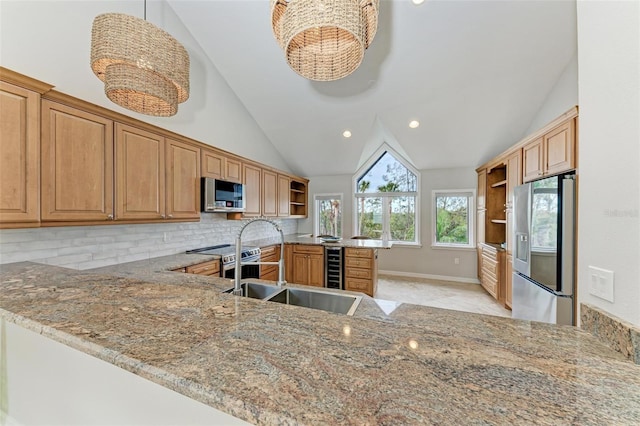 kitchen featuring beverage cooler, appliances with stainless steel finishes, a peninsula, light stone countertops, and open shelves