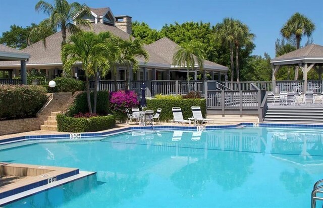 pool with stairs and a gazebo