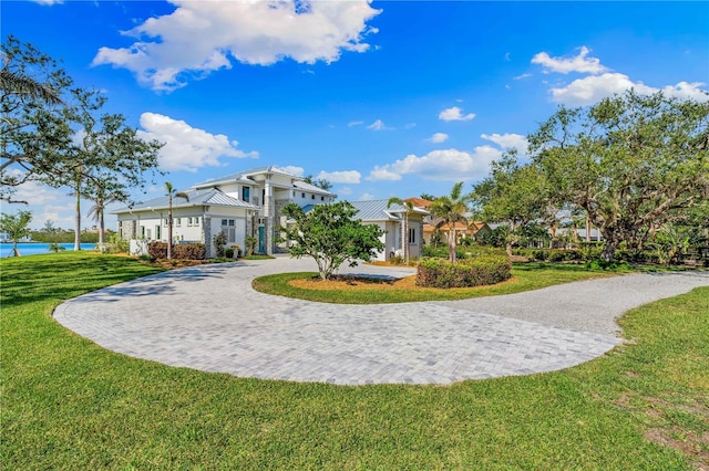 view of community featuring a lawn and a water view