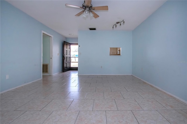 tiled spare room with ceiling fan