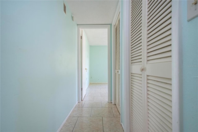 hall featuring light tile patterned floors