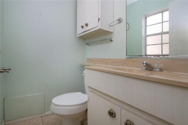 bathroom with vanity, toilet, and tile patterned floors