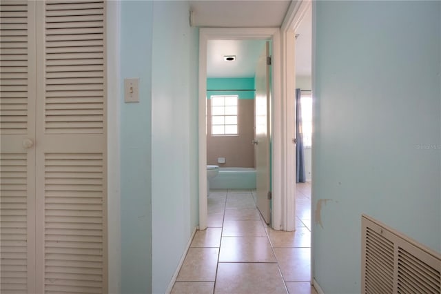 hall featuring light tile patterned floors