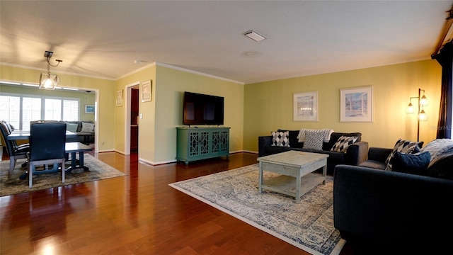 living room with crown molding and dark hardwood / wood-style floors