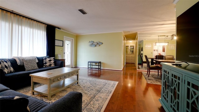 living room with hardwood / wood-style flooring and ornamental molding