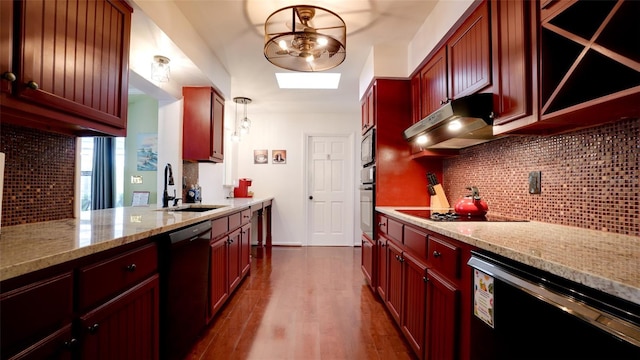 kitchen featuring pendant lighting, sink, decorative backsplash, light stone counters, and black appliances