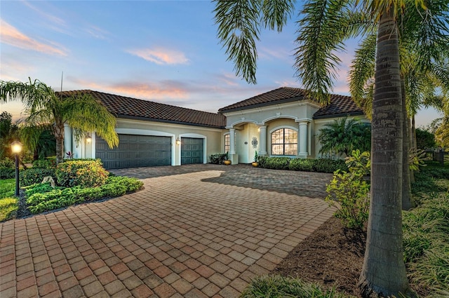 mediterranean / spanish-style home with a garage