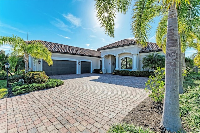 mediterranean / spanish house with a garage