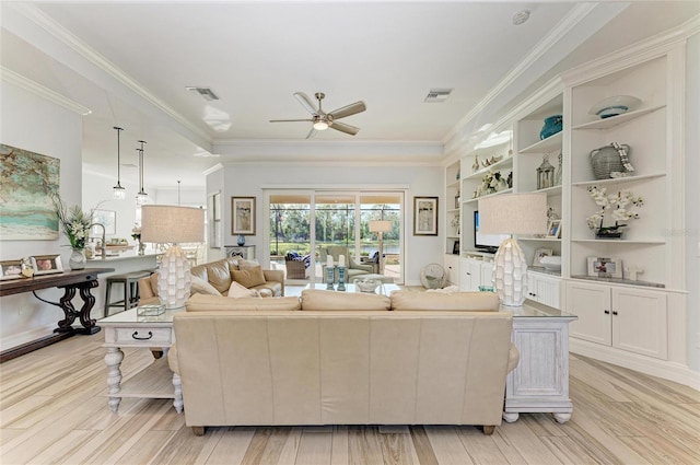 living room featuring ornamental molding, ceiling fan, and light hardwood / wood-style floors