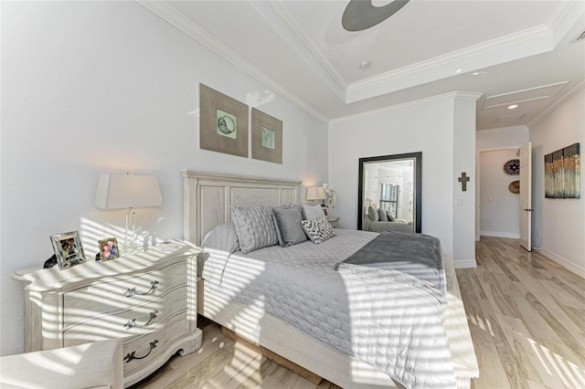 bedroom featuring ceiling fan, ornamental molding, and light hardwood / wood-style flooring