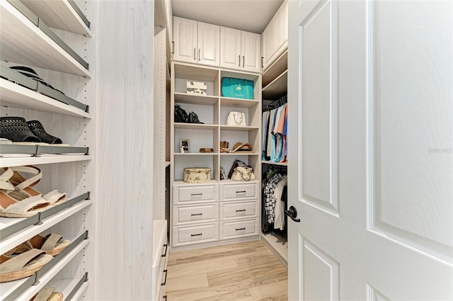 spacious closet featuring light hardwood / wood-style floors