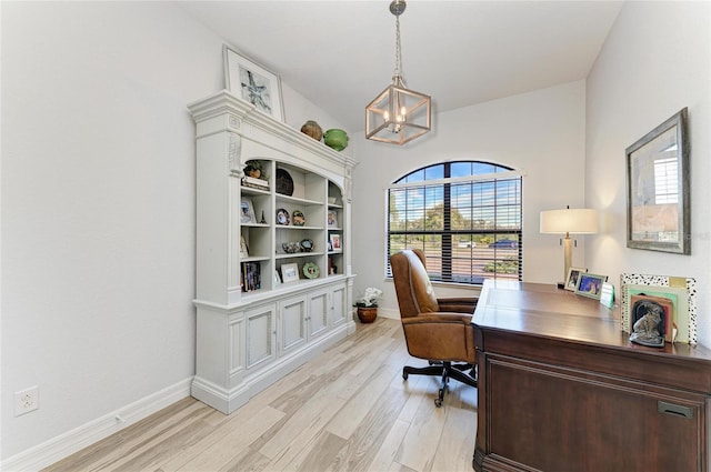 home office featuring a chandelier and light hardwood / wood-style flooring