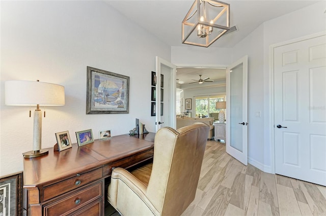 office space featuring a chandelier and light wood-type flooring