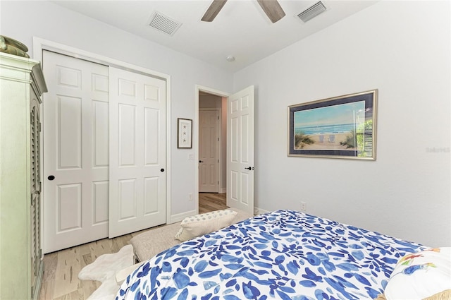 bedroom featuring light hardwood / wood-style floors, a closet, and ceiling fan