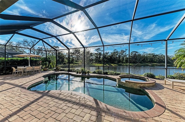 view of swimming pool featuring a water view, an in ground hot tub, a lanai, and a patio area