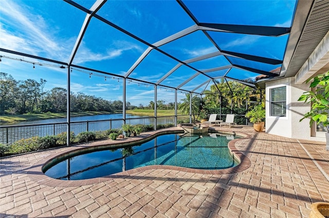 view of pool with a patio area, an in ground hot tub, a water view, and glass enclosure