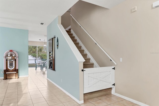 staircase featuring tile patterned flooring