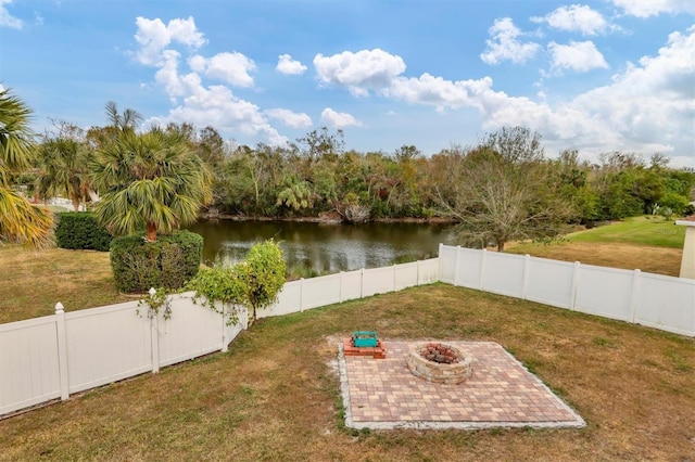 view of yard featuring a fire pit, a patio, and a water view