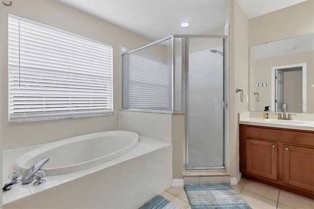 bathroom featuring tile patterned flooring, plus walk in shower, and vanity