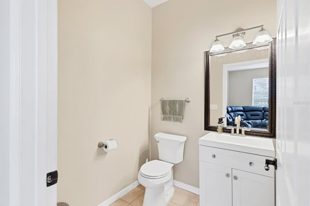 bathroom featuring vanity, tile patterned floors, and toilet