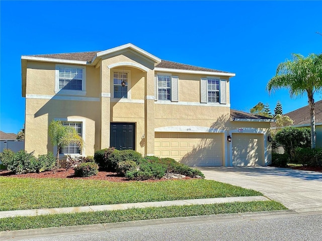 view of front of property featuring a garage and a front yard