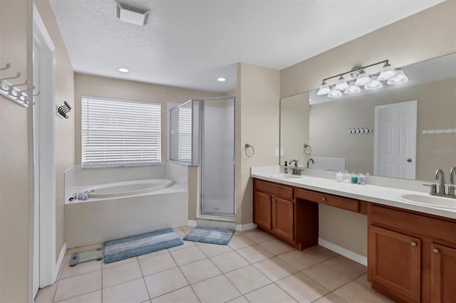 bathroom featuring vanity, tile patterned flooring, independent shower and bath, and a textured ceiling