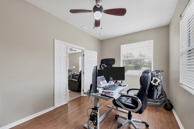 office with hardwood / wood-style flooring and ceiling fan