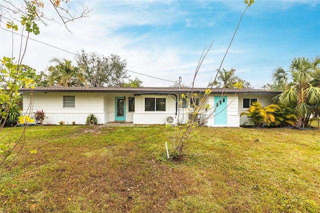 ranch-style house with a front yard and ac unit