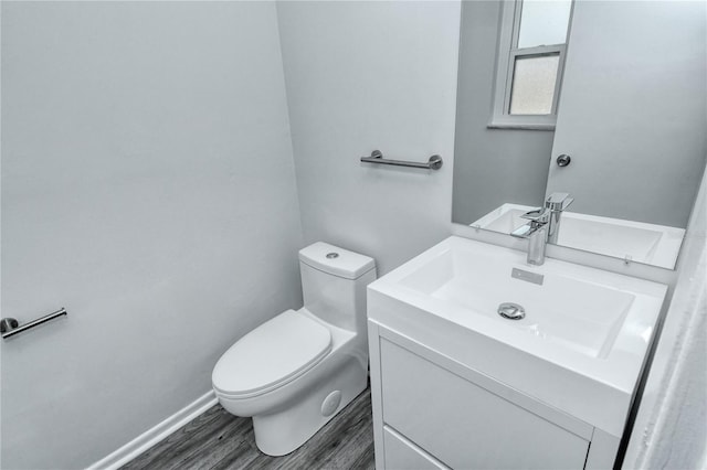 bathroom featuring hardwood / wood-style flooring, vanity, and toilet