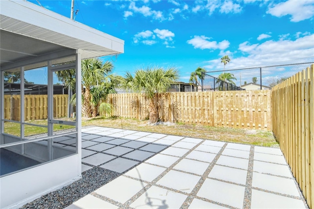 view of patio featuring a sunroom