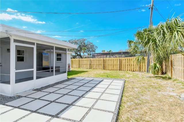 view of yard featuring a patio and a sunroom