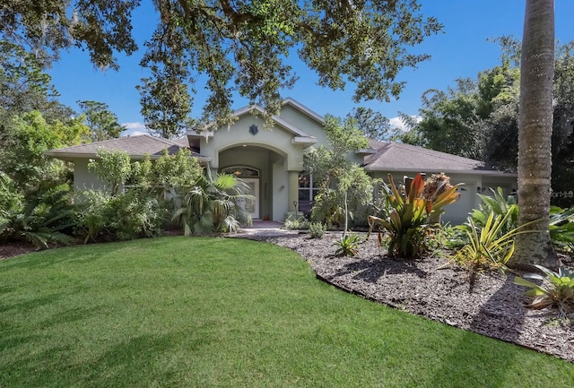 view of front of home with a garage and a front lawn