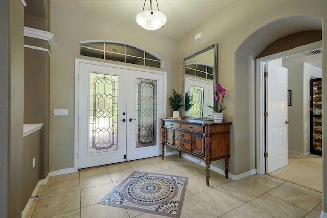 entrance foyer featuring light tile patterned flooring and french doors