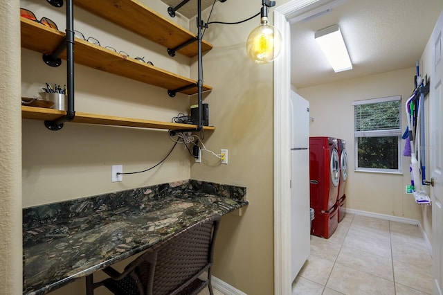 bathroom with separate washer and dryer and tile patterned flooring