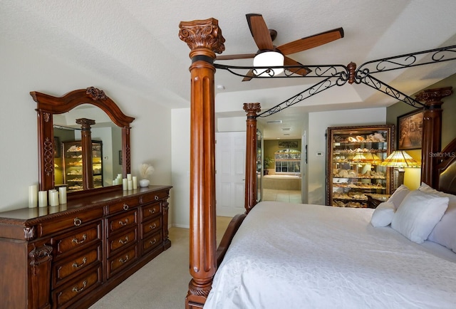 carpeted bedroom featuring a textured ceiling and ensuite bath